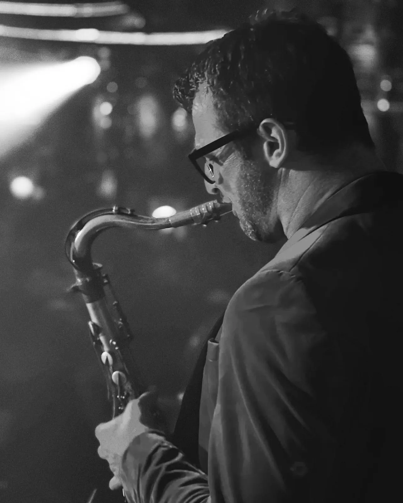 George Kash playing saxophone, black and white portrait